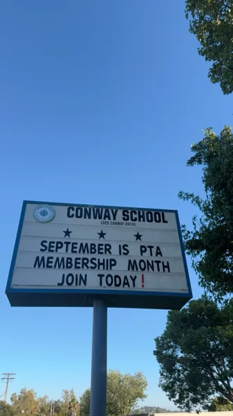 An outdoor school marquee sign for Conway School that displays the message "September is PTA Membership Month — Join Today!" against a clear blue sky.