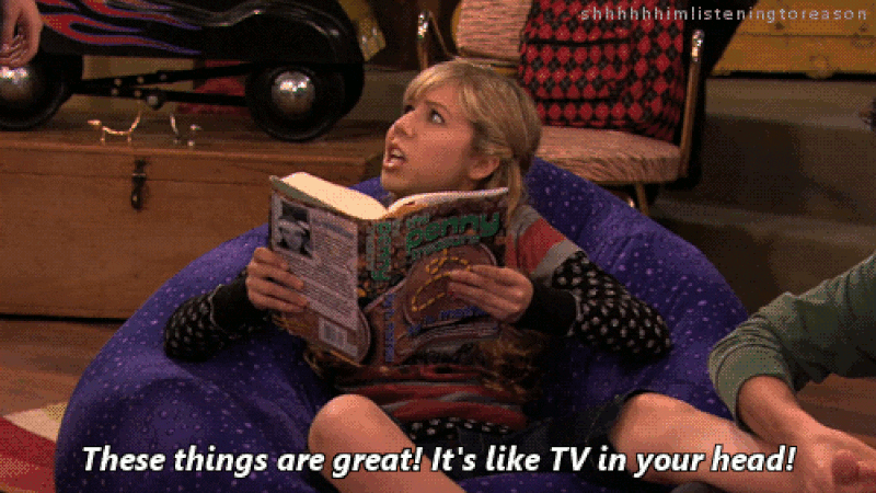 A young blonde girl sits in a purple bean bag chair holding a book, with the caption "These things are great! It's like TV in your head!