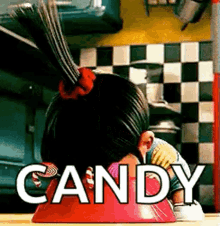 An animated child character leans forward over a red surface with the word "CANDY" displayed in white text.